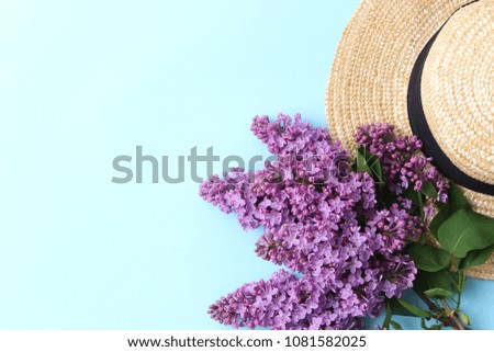 lilac and straw hat on a colored background with place for inserting text. minimalism, design, top view. flatlay 