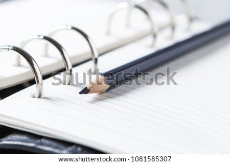 Pencil on the background of the Notepad. Focus on the tip.