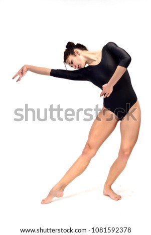 A girl in a brown bodysuit is doing stretching excercises (isolation on white)