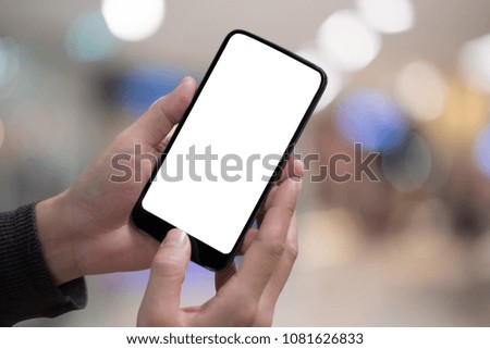 Technology, Communication and People concept - close up of man hands with smartphone texting message on city street blurred background. blank screen for graphics display montage.