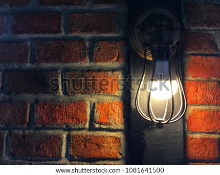 The light bulb and the red bricks background in concept vintage style