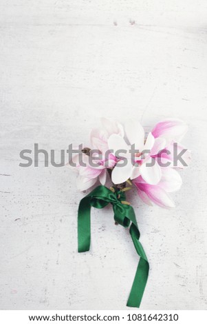 Magnolia flowers bouquet flat lay composition on white wooden background