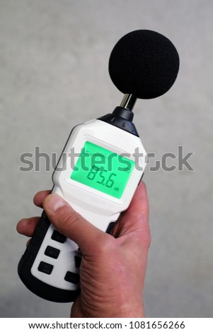 Hand holding sound level meter Royalty-Free Stock Photo #1081656266