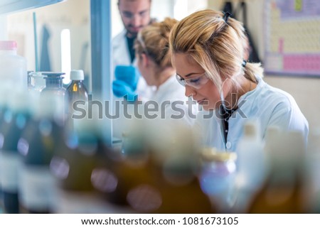 Beautiful young woman scientist in laboratory working. Young female scientist doing some research. Royalty-Free Stock Photo #1081673105
