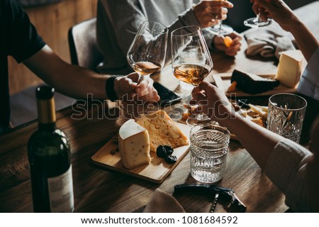 Wine and cheese served for a friendly party in a bar or a restaurant. Royalty-Free Stock Photo #1081684592
