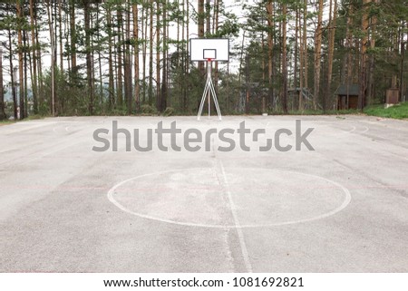 Concrete basketball court in the forest, empty with no people due to outbreak of deadly Coronavirus (COVID-19) global pandemic crisis