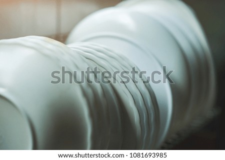 dishes and bowls are stacked on the shelves.