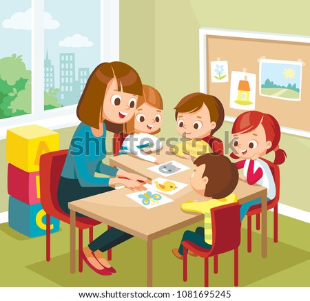 Cute children kids learning new words with flash cards in the class at primary school, pre-school. Teacher  teaches kids babies new words. Art classroom interior with pupils. Teacher with pupils.