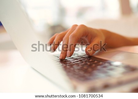 closeup elegant beautiful female hands typing on  keyboard mouse of a laptop computer,in  cafe ,successful business woman,working,looking for information,browsing internet, chatting,blurred background