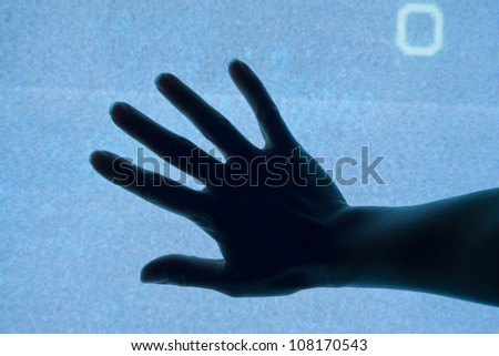 Silhouette of hand on the screen abstract concept