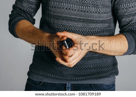 Man's hands using mobile phone. Close-up image