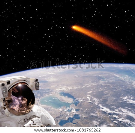Astronaut and comet that flies above the earth. The elements of this image furnished by NASA.