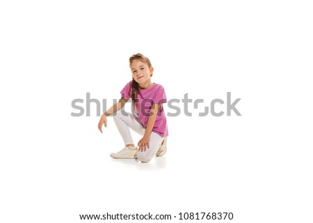 The kids dance school, ballet, hiphop, street, funky and modern dancers on white studio background. Happy girl is showing aerobic and dance element. Teen in hip hop style.