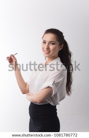 young business girl in white shirt and black skirt on white isolated background holds in hands black pen and smiles
