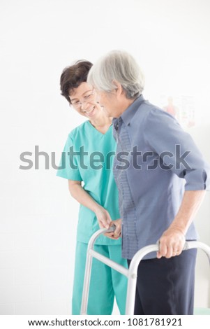 Asian old female train use walker with health worker, stroke patient use walker, walk training, rehabilitation process 