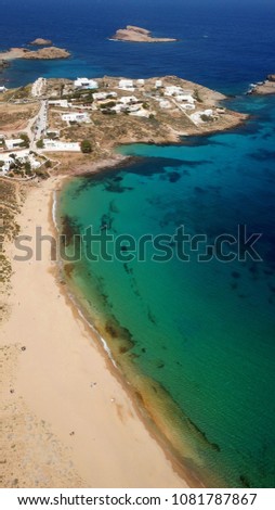 Aerial drone bird's eye view of iconic turquoise clear water of Agios Sostis in island of Mykonos, Cyclades, Greece