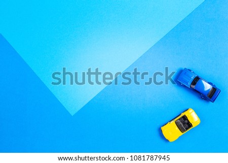 Toy background. Colorful toy cars on blue background.