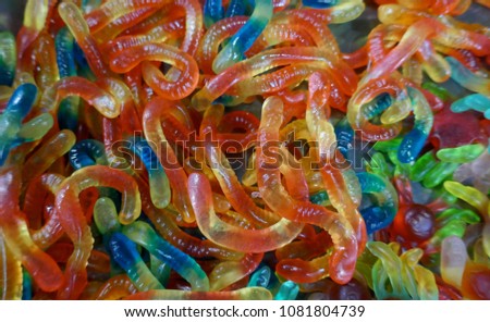  Rubber snakes or worms. Jelly candies. Colorful mix of sweets, close up.