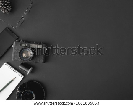 top view office table concept with retro camera, notebook and coffee cup on black Color table background with copy space