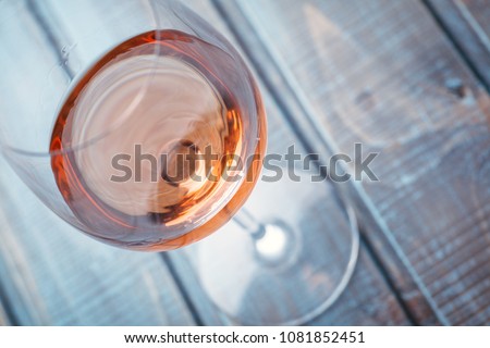 Glass of rose wine on a blue wooden table at a bar Royalty-Free Stock Photo #1081852451