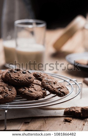 Chocolate chip cookies on wooden table.Chocolate chip cookies shot with milk on the morning time.