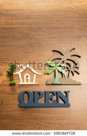 Wooden sign of House and Palm tree with Open sign