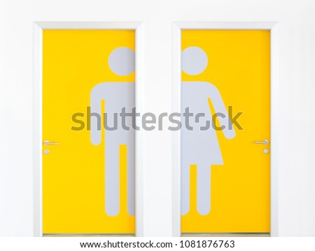 Men and women symbols on the yellow public toilet entrance doors.