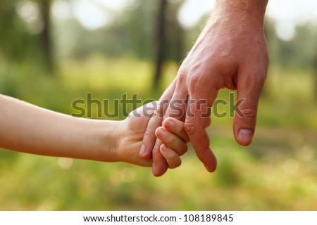 father's hand lead his child son in summer forest nature outdoor, trust family concept Royalty-Free Stock Photo #108189845
