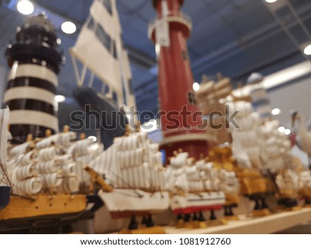 blur photo of Ship type such as Sailing ship and Brig;And there are other things such as a Lighthouse and Stork bird model