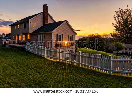 Beautiful colonial American house at sunset Royalty-Free Stock Photo #1081937156