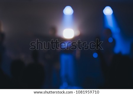 Blurred photo of Christian worship God together in Church  and light bokeh effect.raised hand and praise the LORD. concert background.