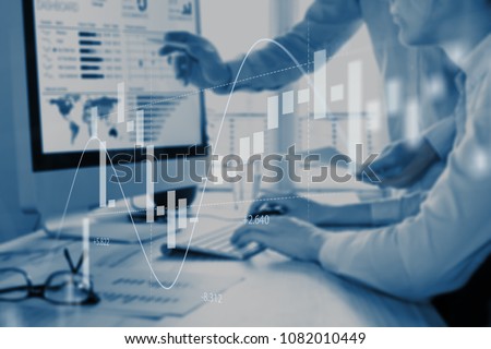 Abstract finance concept with people discussing financial data on a business analytics dashboard on computer screen in background and stock market investment chart in foreground