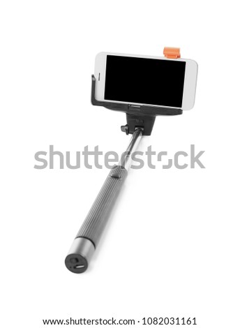 Selfie stick with mobile phone on white background