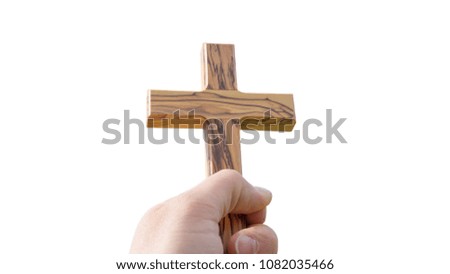 holding wooden cross isolated on white