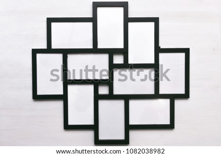 Blank photo picture frame isolated on white wooden board background.