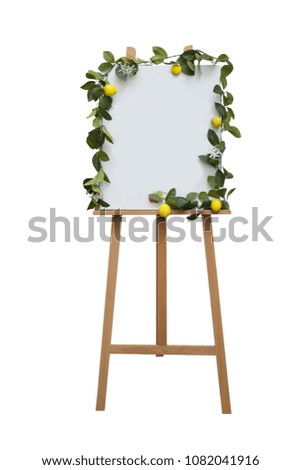 Blank canvas flip board with leaves and lemon decoration around white area isolated on white background 