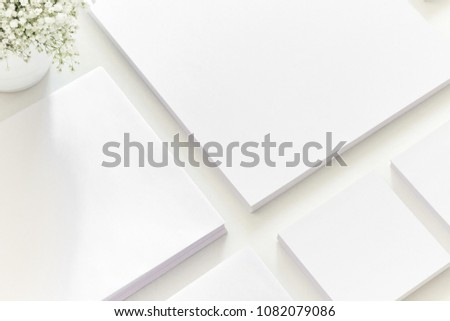 White workspace. Empty white stationery with a coffee and plant. Corporate identity set. Flat lay, top view, copy space