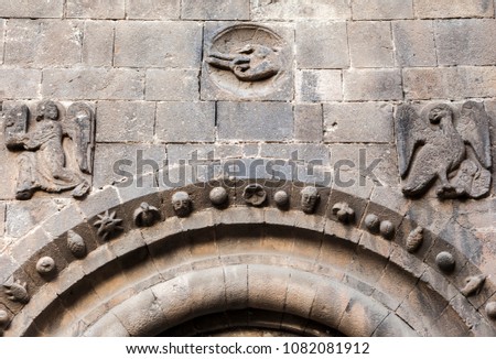 Ancient medieval symbols in door entrance of monastery benedictine of Sant Pau del Camp, romanesque style in El Raval quarter of Barcelona.Spain.