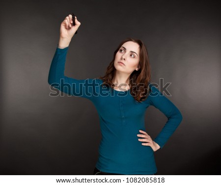 Beautiful thoughtful businesswoman holding a marker on her hands