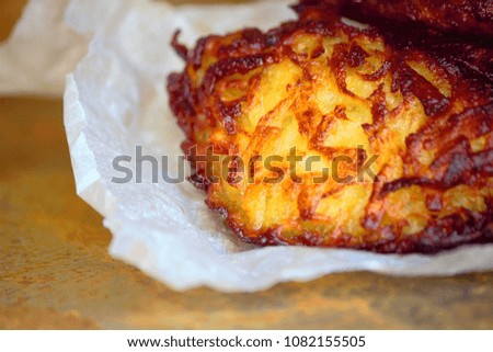 On the table, fritters from potatoes (dranniki). Vegetarian food. Gourmet food. Dietary food. Can be used as a background image in which space is copied.