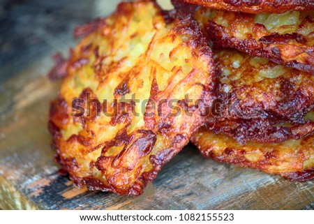 On the table, fritters from potatoes (dranniki). Vegetarian food. Gourmet food. Dietary food. Can be used as a background image in which space is copied.