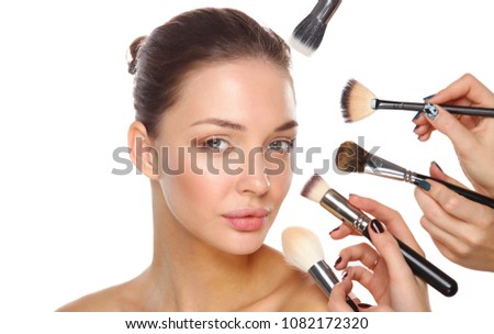 Closeup portrait picture of beautiful woman with brushes