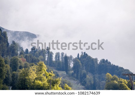 Picture of mountain slopes with vegetation and cloudy sky