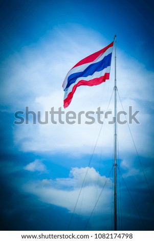 Thai flag waving at the top of the pole.