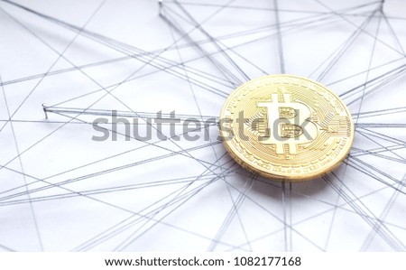 Physical Bitcoin suspended in sewing thread and pins isolated blockchain network concept
