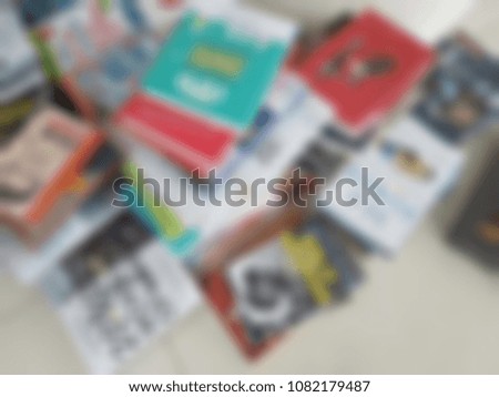 A lot of books that putting on the floor by waiting for arranging. It's a blurred picture. Education and study concept.