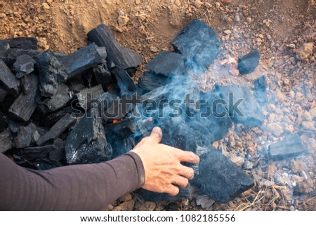 Make a fire with charcoal on land. Photo of smoldering ashes of a bonfire