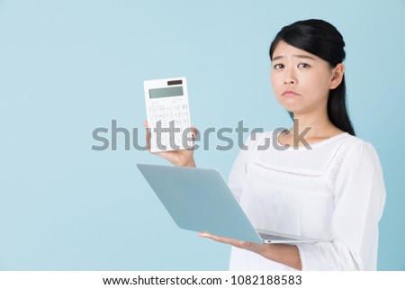 portrait of young asian woman isolated on blue background
