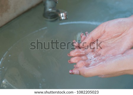 Women wash their hands properly before eating with water tap