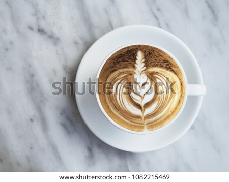 Flat lay photography of coffee with beautiful latte art on white marble background. Desk with latte art coffee. Lifestyle inspiration.